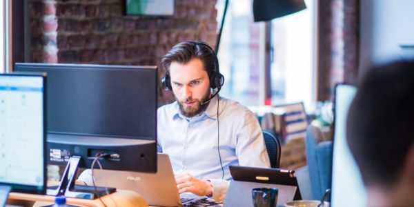 selective-focus-photo-of-man-in-official-shirt-sitting-in-2451645